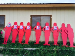 Silent Witnesses are the wooden, life-sized red silhouettes of women which are stark reminders of the violence that exists on our reservation and other communities across the world. The red silhouettes are placed at different public places by members of the White Buffalo Calf Woman Society, Inc. The Silent Witnesses remind us of how common incidents of domestic violence actually are. Each one of these silent witnesses represents a Lakota woman from the Rosebud Reservation murdered by her husband or domestic partner. Violent acts leading to the murder of your partner are not Lakota traditions. Sadly, we still see too many Lakota women are physically abused on our reservations.